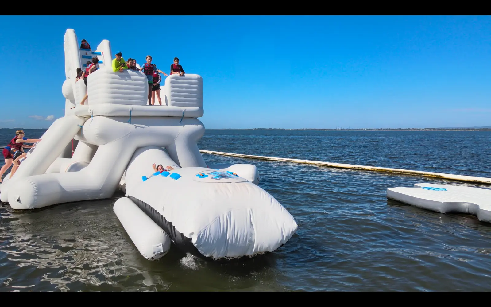 Young Aqua Warriors preparing to launch from the inflatable course over Moreton Bay