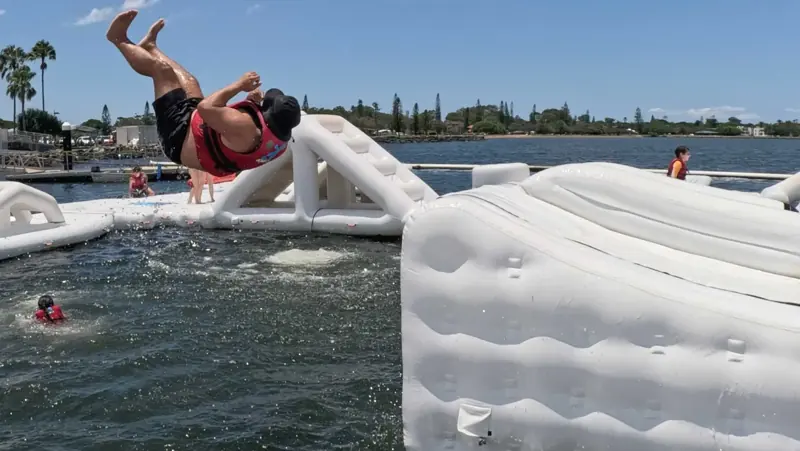 Aqua Warrior backflipping above the water course