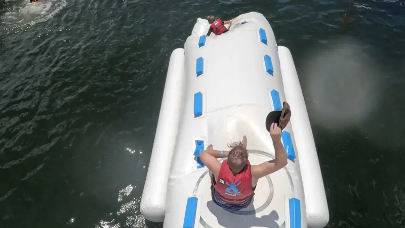 Overhead view of Aqua Warriors crossing a long inflatable obstacle