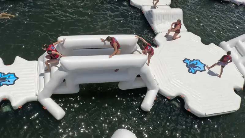Overhead view of guests moving through an Aqua Warrior obstacle