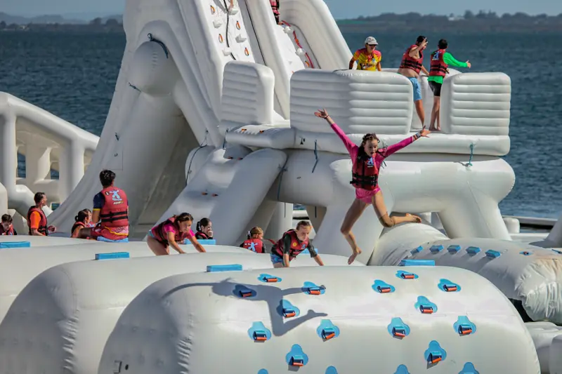 A Warrior jumping from an inflatable obstacle