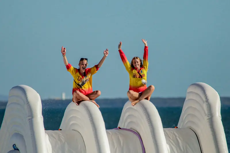 Two Aqua Warrior lifeguards at the top of the slide
